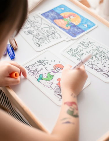 person drawing on white paper