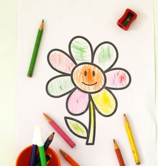 a child's drawing of a flower with crayons